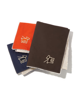 canvas fleece dog blanket in orange, brown, and blue