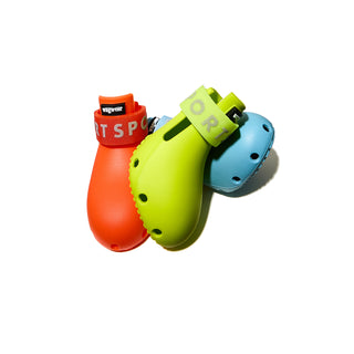 Three colorful dog boots in red, green, and blue on a white background